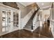 Beautiful staircase with dark wood steps, decorative carpet runner, and white trim at 12813 Chapel Square St, Carmel, IN 46032