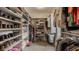 Bright walk-in closet featuring custom shelving and ample hanging space for organized storage solutions at 12813 Chapel Square St, Carmel, IN 46032