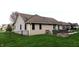 Spacious backyard with a well-manicured lawn, mature trees, and a glimpse of the home's exterior at 13116 N Departure W Blvd, Camby, IN 46113