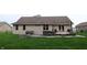 Private backyard features a hot tub, fire pit, and patio area, perfect for outdoor gatherings and relaxation at 13116 N Departure W Blvd, Camby, IN 46113
