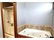 A stylish bathroom features a corner soaking tub and a glass-enclosed shower with a neutral tile surround at 13116 N Departure W Blvd, Camby, IN 46113