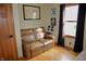 Cozy bedroom features a plush leather couch, light wood flooring, and natural light from the window at 13116 N Departure W Blvd, Camby, IN 46113