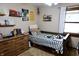 Cozy bedroom with a twin bed, soft carpet, and decor on shelves and walls at 13116 N Departure W Blvd, Camby, IN 46113