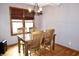 This dining room features hardwood floors, a modern chandelier, and a beautiful view from the windows at 13116 N Departure W Blvd, Camby, IN 46113