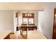 The dining room has a wood table, hardwood floors, and windows with wood trim that give plenty of light at 13116 N Departure W Blvd, Camby, IN 46113