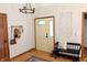 Welcoming entryway boasts hardwood floors, a chandelier, and convenient coat rack at 13116 N Departure W Blvd, Camby, IN 46113