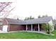 Eye-catching brick home with an attached garage, well-maintained lawn, and inviting covered front porch at 13116 N Departure W Blvd, Camby, IN 46113