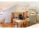 Open kitchen with stainless steel appliances, an island, and wooden cabinetry at 13116 N Departure W Blvd, Camby, IN 46113