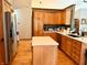 Bright kitchen features an island, stainless steel appliances, and plenty of cabinet space at 13116 N Departure W Blvd, Camby, IN 46113