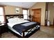 Comfortable main bedroom with plush carpet, a king-sized bed, and plenty of natural light at 13116 N Departure W Blvd, Camby, IN 46113