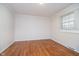 Bedroom features hardwood floors, a window, and neutral paint at 1313 Roseway Dr, Indianapolis, IN 46219