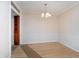 Empty dining room showcasing chair rail detail, chandelier, and wood-look flooring at 1313 Roseway Dr, Indianapolis, IN 46219