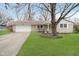 Charming brick ranch home featuring an attached garage and a well-maintained front lawn at 1313 Roseway Dr, Indianapolis, IN 46219
