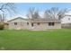 Back exterior of home with a large yard at 1313 Roseway Dr, Indianapolis, IN 46219