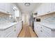 A modern kitchen boasts white cabinetry, stainless steel appliances, and stylish countertops at 1313 Roseway Dr, Indianapolis, IN 46219