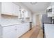 An updated kitchen features white cabinets, stainless appliances, and a bright, airy feel at 1313 Roseway Dr, Indianapolis, IN 46219