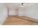 An empty living room connecting to the dining room, featuring wood-look flooring and a ceiling fan at 1313 Roseway Dr, Indianapolis, IN 46219