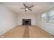 Spacious living room with a brick fireplace, wood-look flooring, and a ceiling fan at 1313 Roseway Dr, Indianapolis, IN 46219