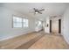 Open-concept layout: living room with views of kitchen, white walls, and wood-look flooring at 1313 Roseway Dr, Indianapolis, IN 46219
