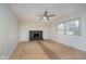 Living room featuring a painted brick fireplace, wood-look flooring and a ceiling fan at 1313 Roseway Dr, Indianapolis, IN 46219
