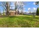 Large backyard featuring patio, trees, lawn, and above-ground pool at 1320 Bittersweet Dr, Greenfield, IN 46140
