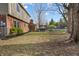 A spacious backyard featuring a hot tub, mature trees, and a partially fenced-in area at 1320 Bittersweet Dr, Greenfield, IN 46140