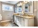 Bathroom featuring double sinks with granite countertops, and decorative mirrors at 1320 Bittersweet Dr, Greenfield, IN 46140