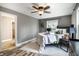 Cozy bedroom with a ceiling fan, wood floors, and a decorative throw blanket at 1320 Bittersweet Dr, Greenfield, IN 46140