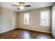 Bedroom with hardwood floors, neutral walls, and two windows at 1320 Bittersweet Dr, Greenfield, IN 46140
