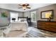 Well-lit bedroom featuring a queen-sized bed, wood floors, and a ceiling fan at 1320 Bittersweet Dr, Greenfield, IN 46140