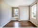Empty bedroom with wood floors, built-in bench, and double door closet at 1320 Bittersweet Dr, Greenfield, IN 46140