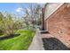 Side view of a brick and siding home with a walkway and partial view of the backyard at 1320 Bittersweet Dr, Greenfield, IN 46140
