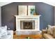 A living room features a tiled fireplace, hardwood floors, and neutral colors at 1320 Bittersweet Dr, Greenfield, IN 46140