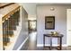 Welcoming foyer with staircase, tiled floor, and elegant console table at 1320 Bittersweet Dr, Greenfield, IN 46140