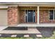 Inviting front entrance with brick accents and a well-maintained walkway at 1320 Bittersweet Dr, Greenfield, IN 46140