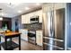 A kitchen features stainless steel appliances, light cabinetry, and a black kitchen island at 1320 Bittersweet Dr, Greenfield, IN 46140