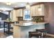 A modern kitchen features granite countertops, mosaic tile backsplash, and stainless steel appliances at 1320 Bittersweet Dr, Greenfield, IN 46140
