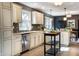 This open-concept kitchen features light cabinetry, mosaic backsplash, and stainless steel appliances at 1320 Bittersweet Dr, Greenfield, IN 46140