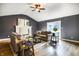 A living room features a high ceiling, a ceiling fan, a fireplace, and hardwood floors at 1320 Bittersweet Dr, Greenfield, IN 46140
