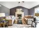 A living room features high ceilings, a ceiling fan, a fireplace, and two sofas at 1320 Bittersweet Dr, Greenfield, IN 46140