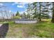 Backyard features an above-ground pool, surrounded by a well-maintained lawn and trees at 1320 Bittersweet Dr, Greenfield, IN 46140