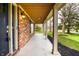 Cozy porch with brick siding and views of the front yard at 1320 Bittersweet Dr, Greenfield, IN 46140