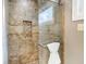 Tiled walk-in shower with glass door and a built-in shelf at 1320 Bittersweet Dr, Greenfield, IN 46140