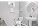 Bathroom featuring a pedestal sink, round mirror, and modern fixtures at 13245 E 131St St, Fishers, IN 46037