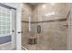 Stylish tiled shower features a built-in seat, glass door, and neutral tones for a spa-like experience at 13245 E 131St St, Fishers, IN 46037