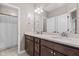 Bathroom featuring double sinks, dark wood cabinetry and neutral countertops at 13245 E 131St St, Fishers, IN 46037