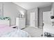 Bedroom featuring lots of light, a pink bedspread, a white dresser, desk, and tasteful decor at 13245 E 131St St, Fishers, IN 46037