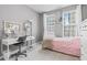 Bedroom with plenty of light with a pink bedspread, a white desk, and a dresser, all in a cozy setting at 13245 E 131St St, Fishers, IN 46037