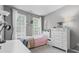 Bedroom featuring lots of light, a pink bedspread, a white desk and a white dresser at 13245 E 131St St, Fishers, IN 46037