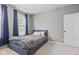 Cozy bedroom with a bed featuring a gray comforter and blue accents, complemented by soft natural light at 13245 E 131St St, Fishers, IN 46037